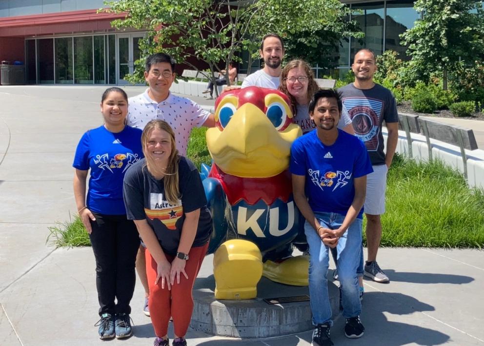 Group of RET members Standing with the Jayhawk statue outside Burge Union.