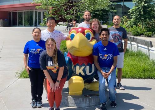 Group of RET members Standing with the Jayhawk statue outside Burge Union.