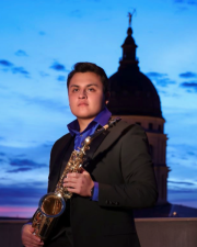 Antonio Carcamo holding a saxophone